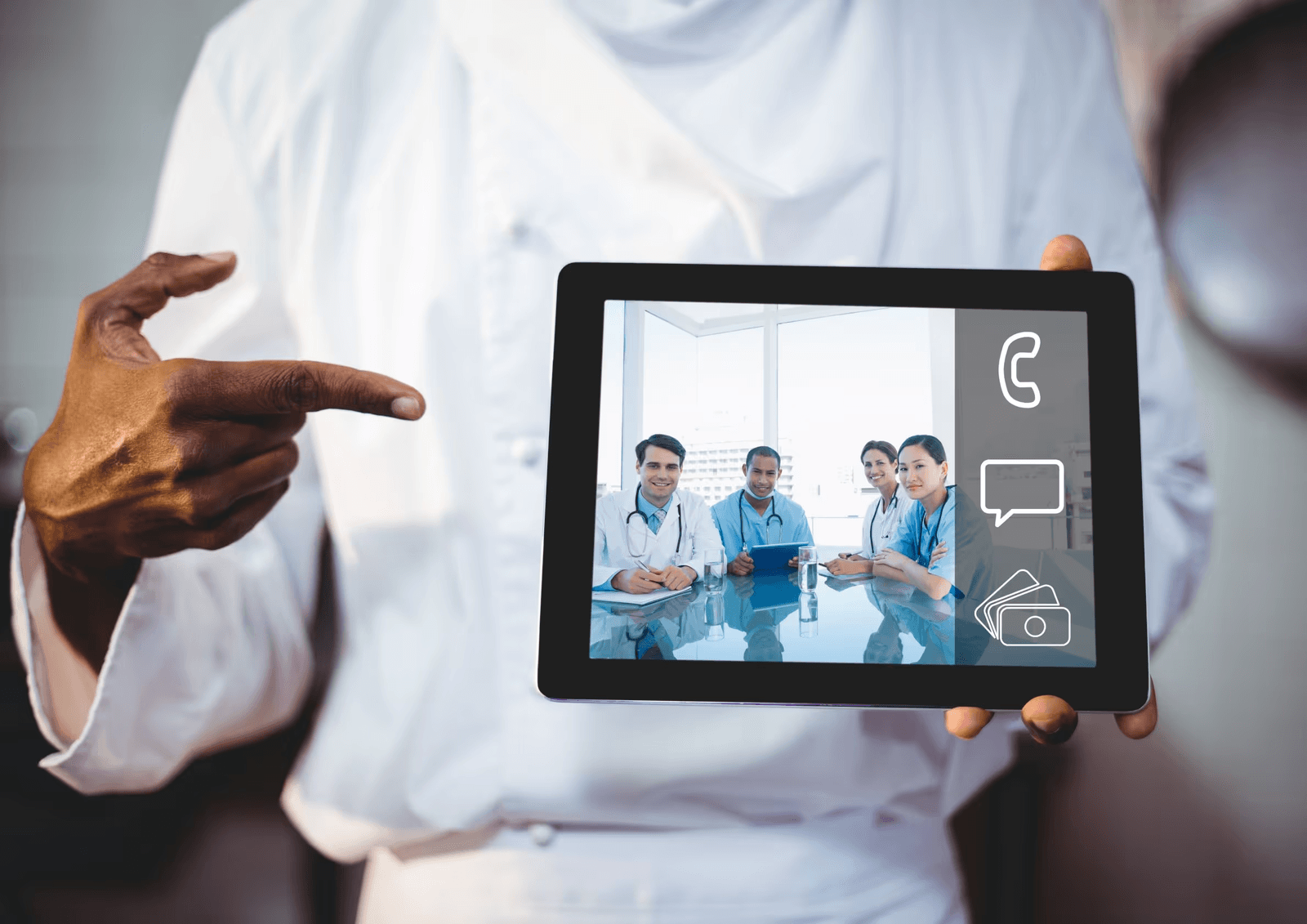 Doctor pointing to a tablet showing a panel of doctors available for e-consultation
