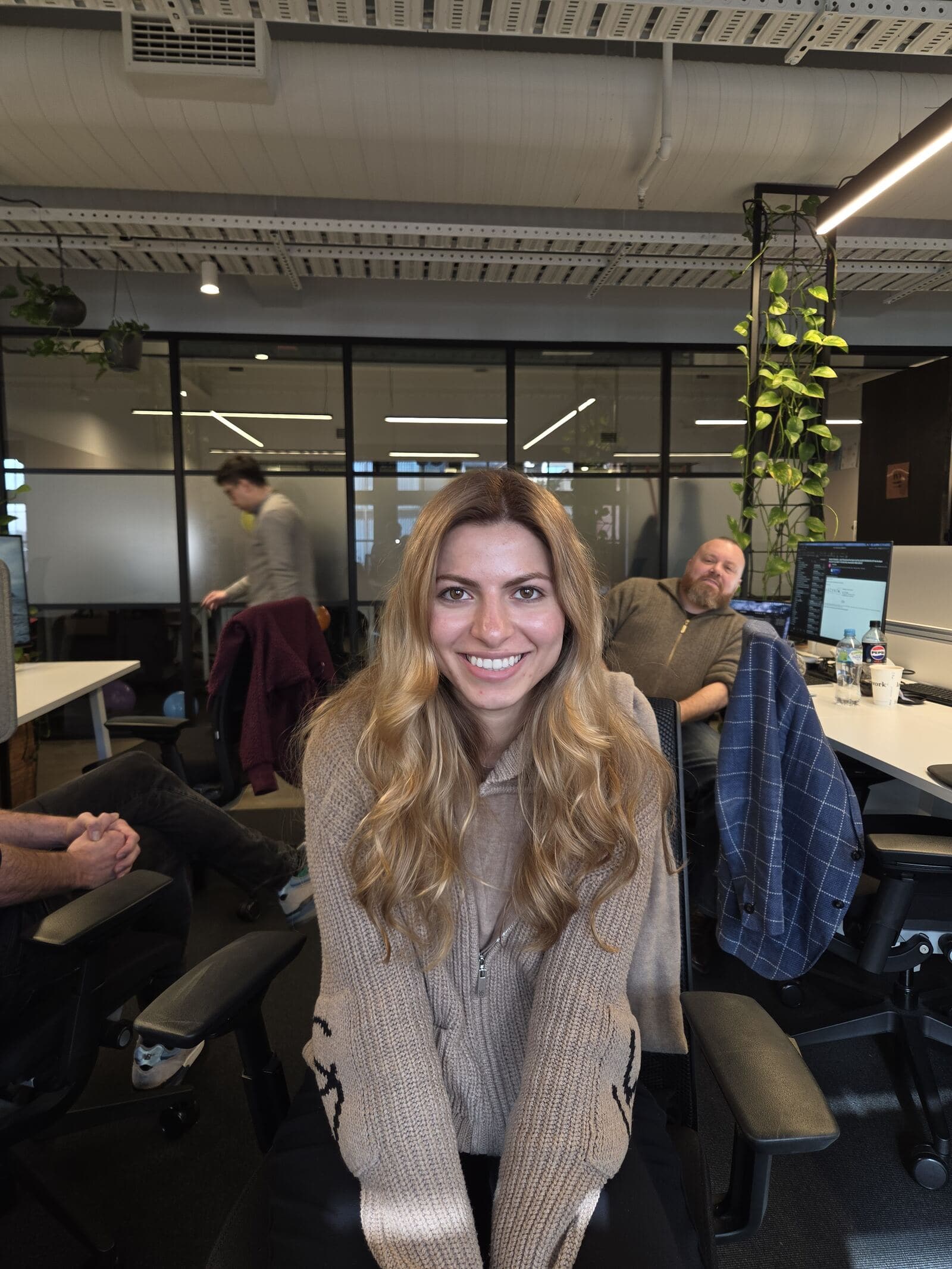 A Teamified team member at their desk, framed webcam-style during an interview