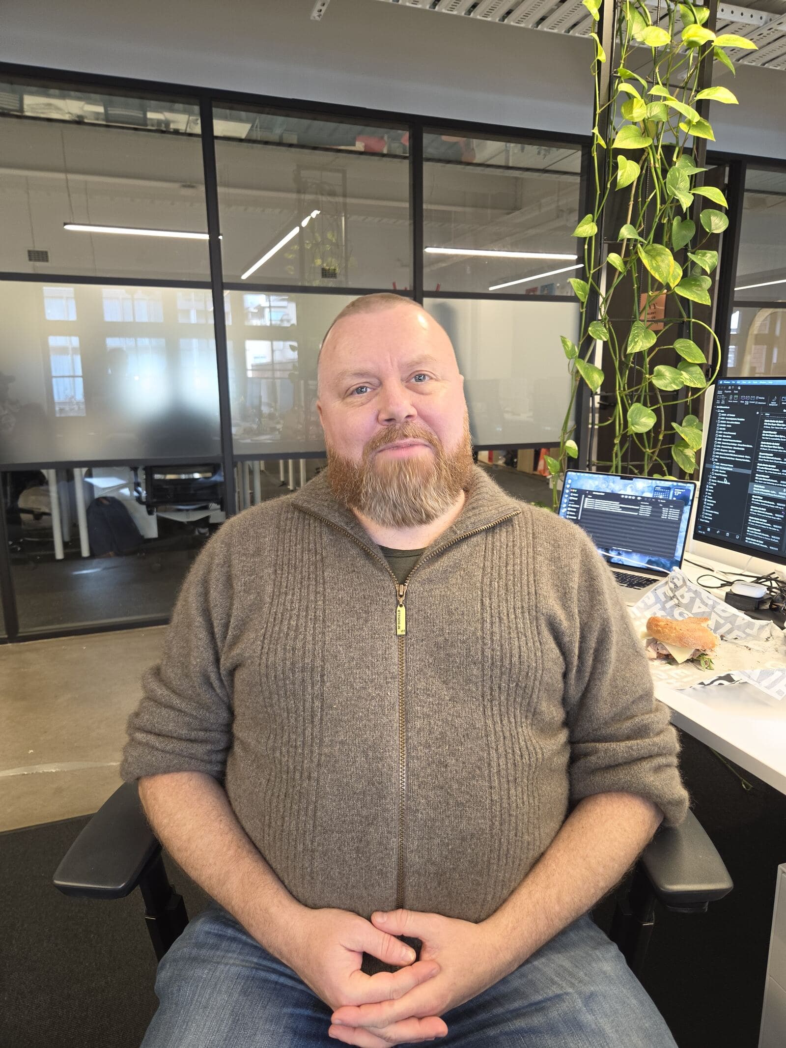 A Teamified team member at their desk, framed webcam-style during an interview